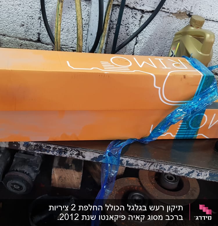 ארגזים כתומים עם כיתוב CV AXLE על שולחן עבודה